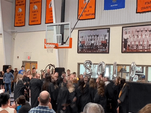 Senior class of 2019 throwing their caps in the air after graduation ceremony
